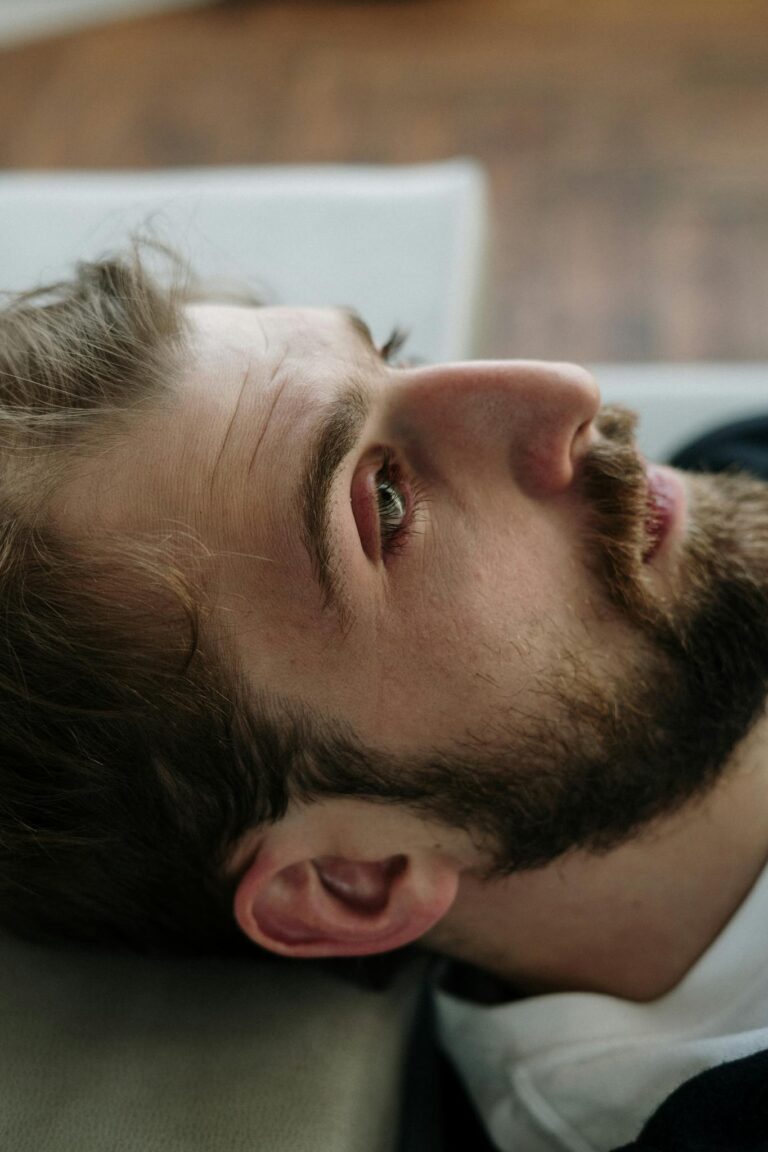 Portrait of a thoughtful bearded man indoors, reflecting on emotions and mental health.